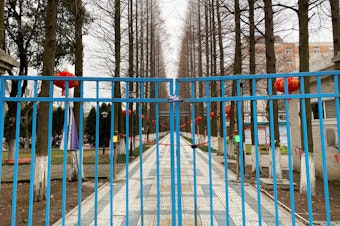 caption: An entrance to a dormitory for Foxconn workers. China's factories normally ramp up production right after the Lunar New Year, but few workers have returned so far this year.