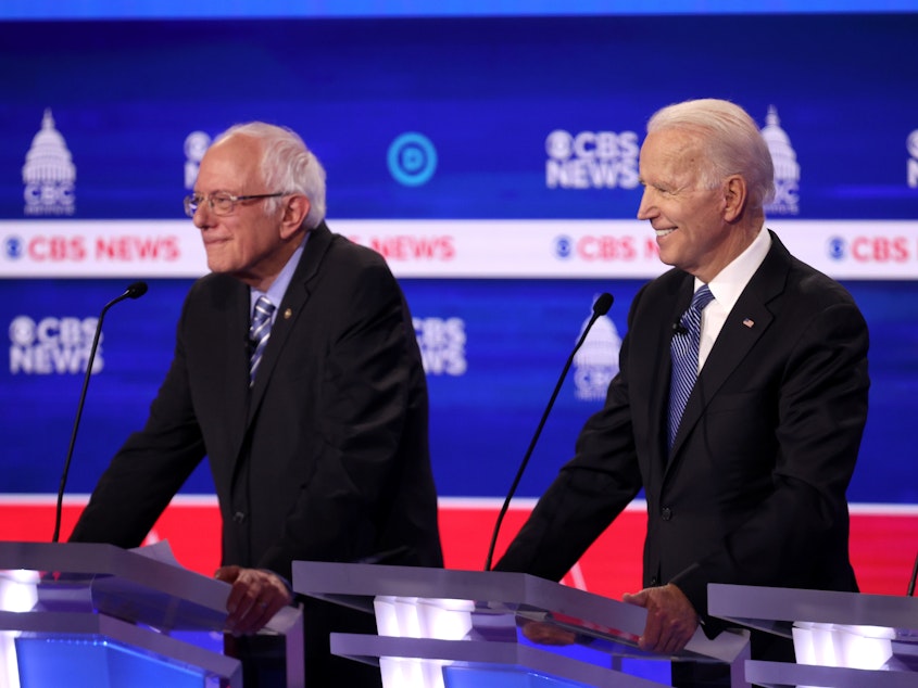 caption: Bernie Sanders and Joe Biden are adapting to the spread of the coronavirus by changing campaign schedules. Louisiana is delaying its primary by more than two months over coronavirus fears.
