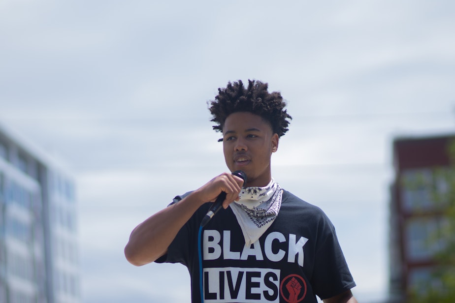 caption: Trey Rudolph, speaking at a rally in Bellevue, says, "We as individuals, may be one vote. But when we all combine our efforts and our energy, we are a collective voice that cannot be ignored.”