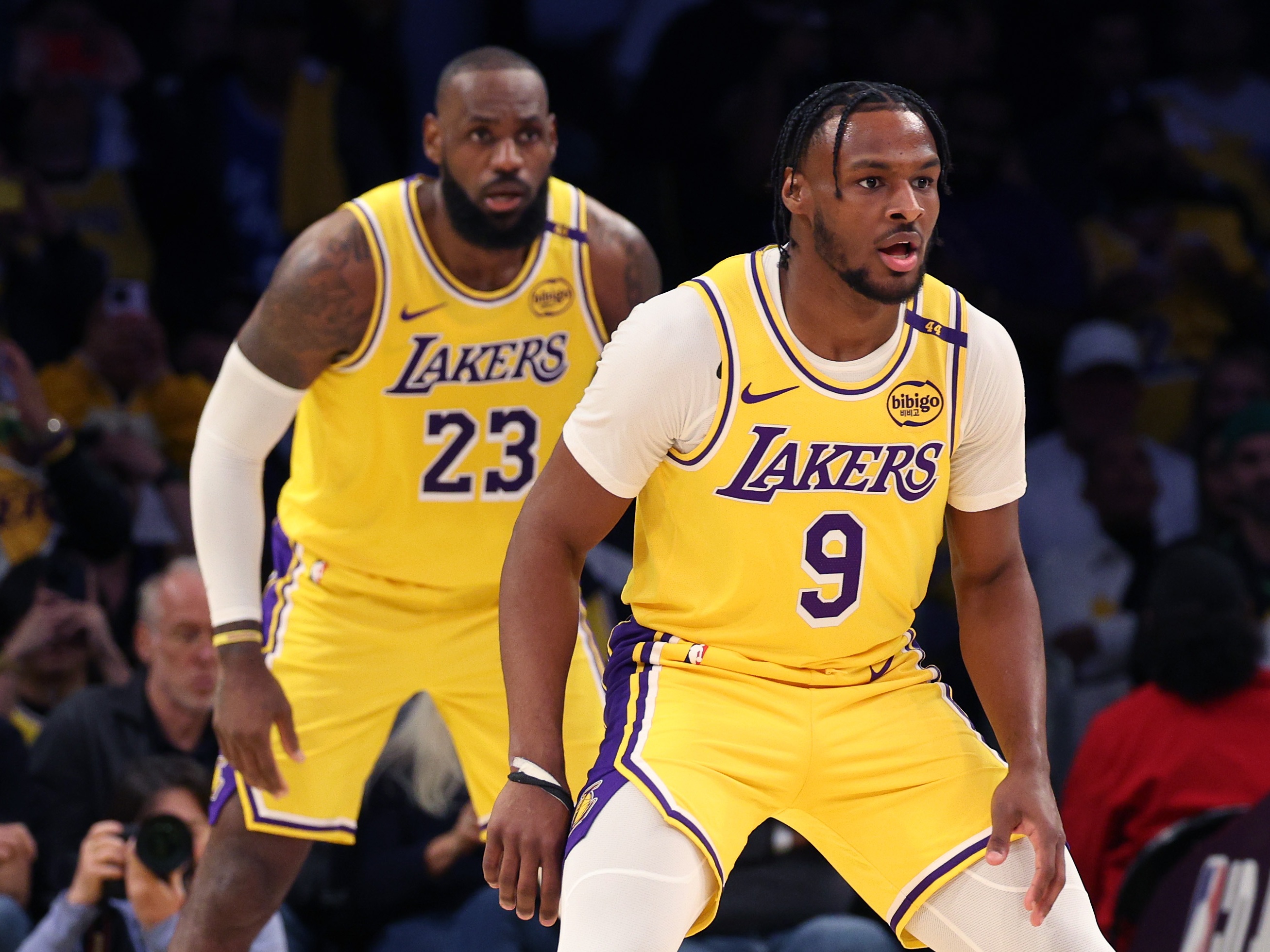 caption: LeBron James, left, and Bronny James of the Lakers play during the second quarter against the Minnesota Timberwolves in Los Angeles on Tuesday.
