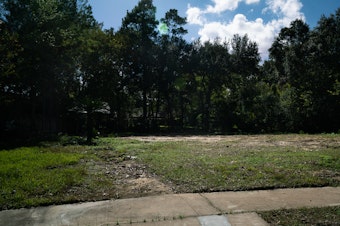 caption: An empty lot where a house once stood in Houston. The former residents moved because of flood damage. A new study suggests that people are moving away from the most flood-prone neighborhoods in cities that are otherwise growing in population.
