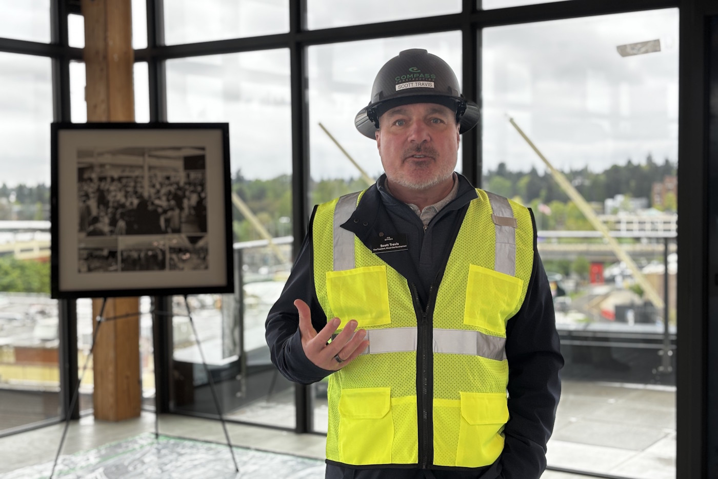 caption: Scott Travis of Simon Property Group in a community space atop one of the new apartment buildings under construction