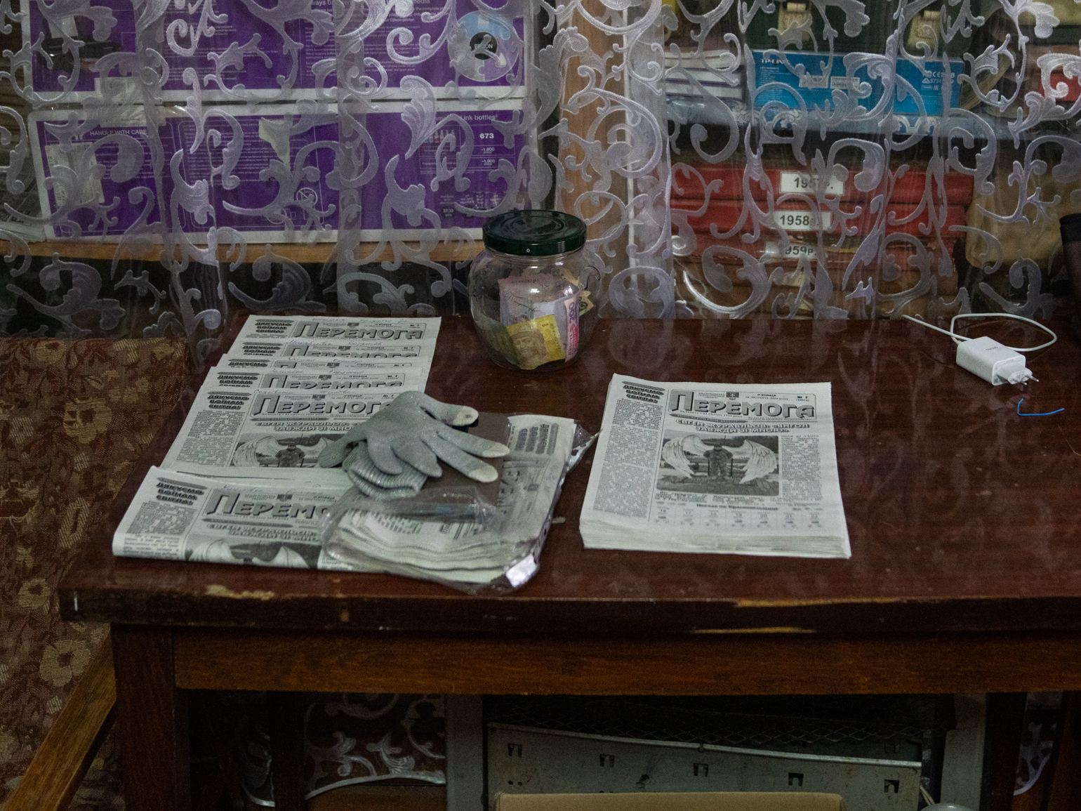 caption: Editions of <em>Peremoha</em> sit on a table near the archives.