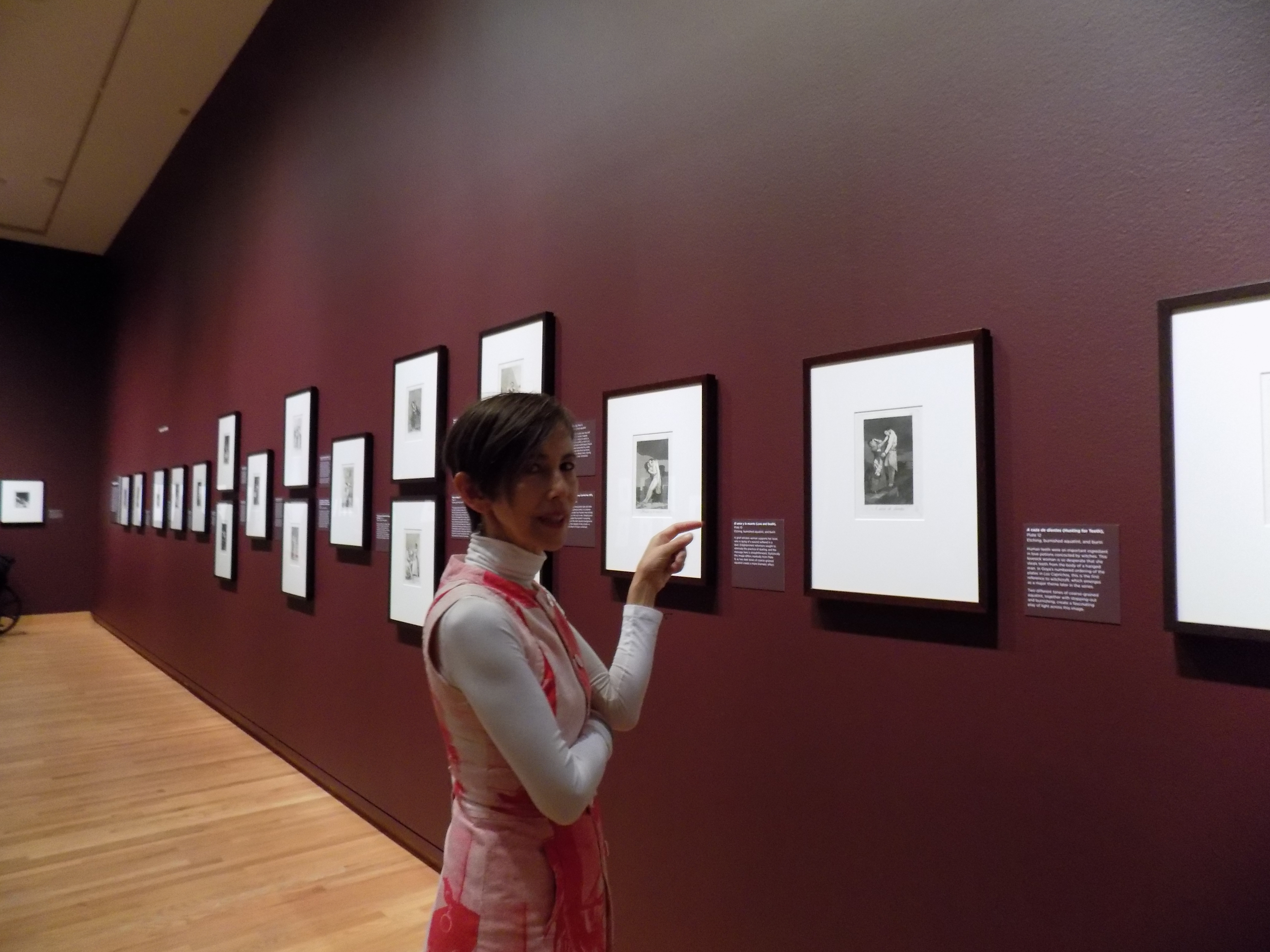 caption: Seattle Art Museum Deputy Director Chiyo Ishikawa appreciates the details in one of Francisco Goya's "Capricho" prints. The work is on display as part of SAM's "Graphic Masters" exhibition