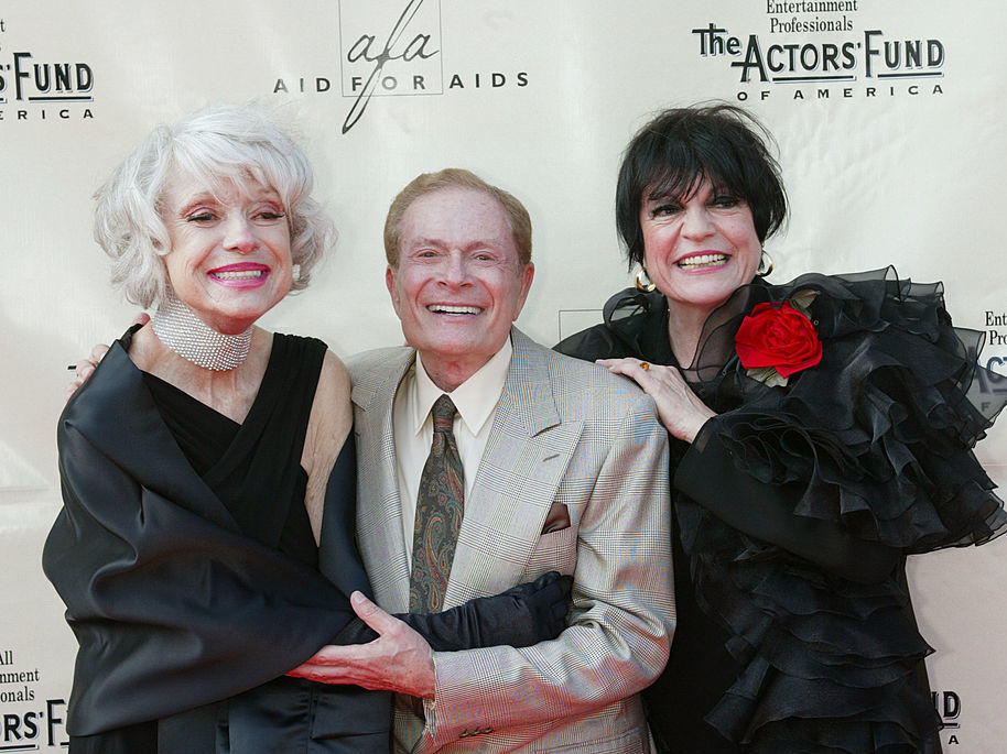 caption: Composer Jerry Herman, flanked by actresses Carol Channing (left) and Jo Anne Worley at a 2002 Tony Awards party in Hollywood.