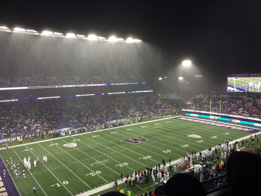 caption: Husky Stadium on a rainy game night in Seattle.