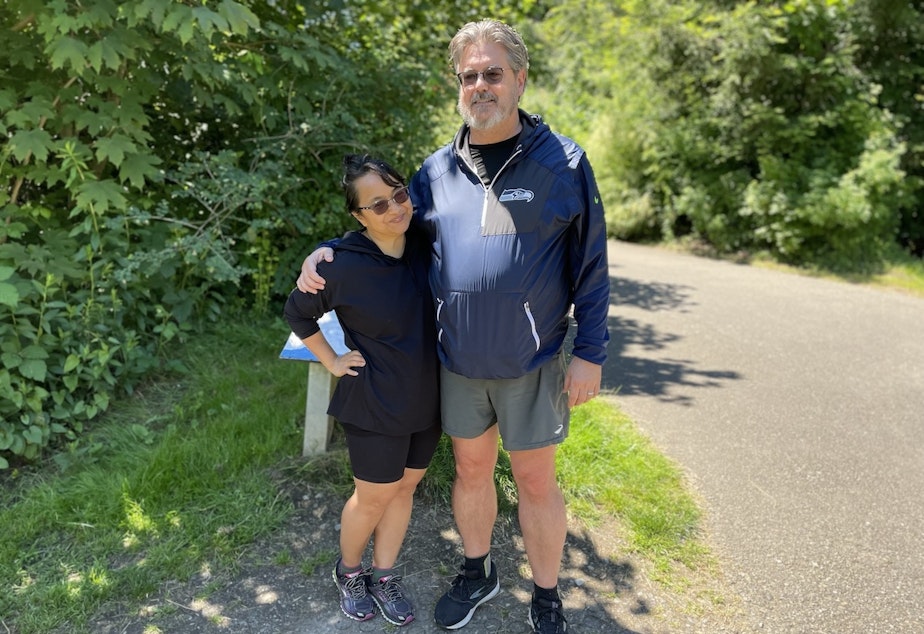 caption: Thaddeus Gunn (right) and Theresa Gunn (left) take a walk around Meadowbrook Pond in Seattle. 