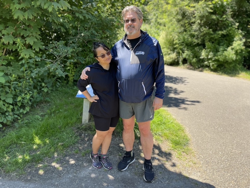 caption: Thaddeus Gunn (right) and Theresa Gunn (left) take a walk around Meadowbrook Pond in Seattle. 