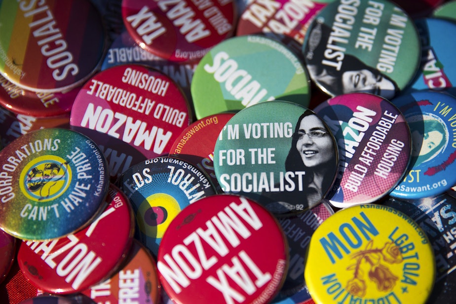 caption: Pins supporting councilmember Kshama Sawant are shown on Sunday, August 4, 2019, at Pratt Park in Seattle.