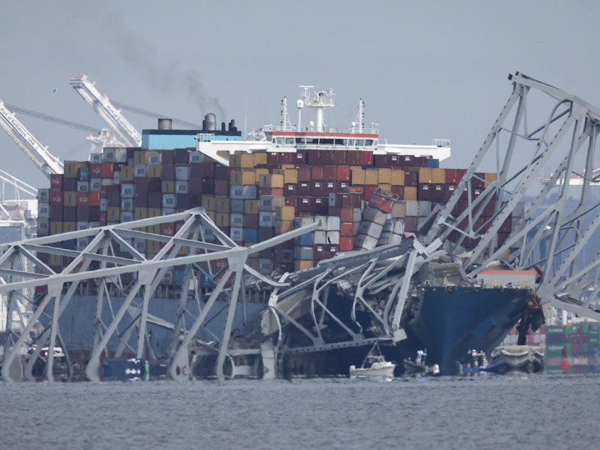 caption: A collapsed section of the Francis Scott Key Bridge in Baltimore is seen in the waters of the Patapsco River. The bridge collapsed early Tuesday after it was struck by a<strong> </strong>984-foot-long cargo ship.