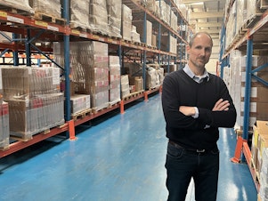 caption: Robert Blanchard, the World Health Organization's team leader in Dubai for emergency operations, stands in one of the organization's warehouses in International Humanitarian City.