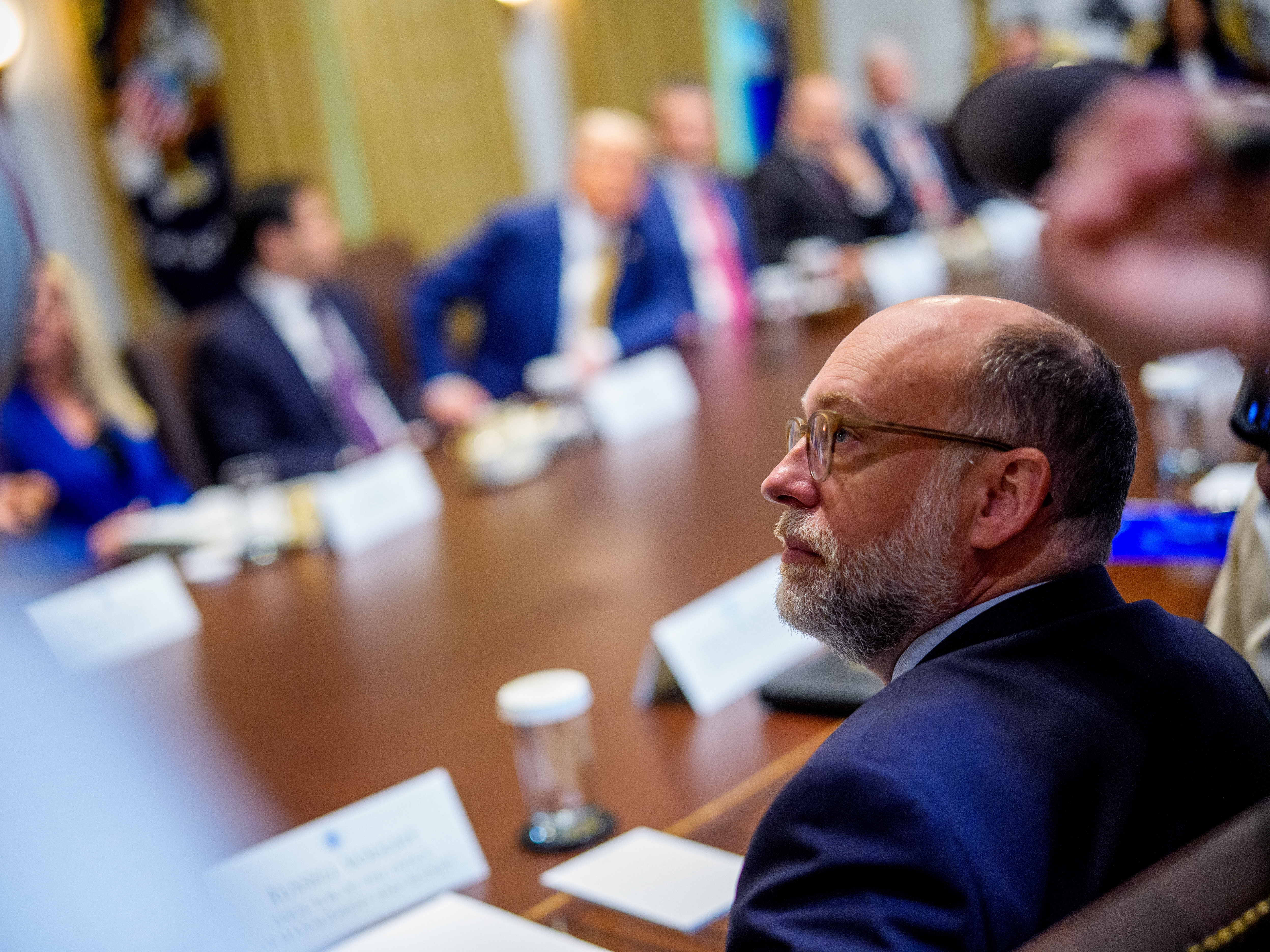 caption: Office of Management and Budget Director Russell Vought attends a Cabinet meeting with President Trump at the White House on July 8.