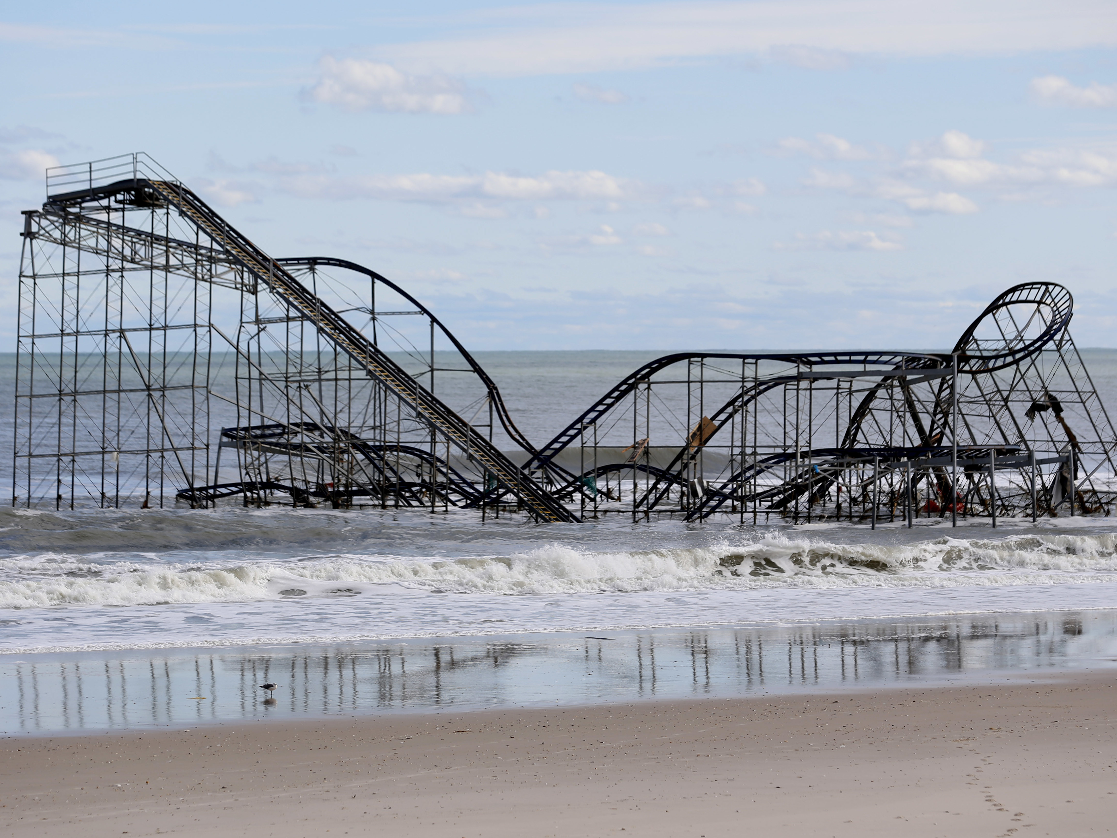 caption: A rollercoaster that once sat on the Funtown Pier in Seaside Heights, N.J., rests in the ocean on Wednesday, Oct. 31, 2012 after the pier was washed away by superstorm Sandy.