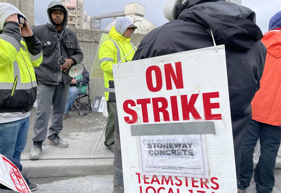 caption: Teamsters union members from Local 174 demonstrate outside the Ash Grove Cement plant and Stoneway Concrete yard on East Marginal Way South near the West Seattle Bridge entrance.