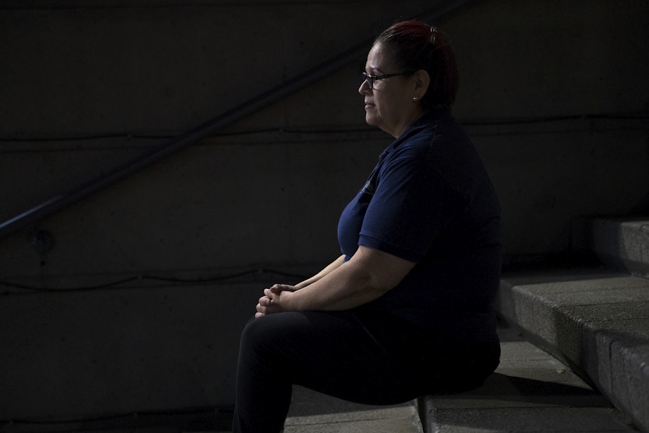 caption: A woman who works in a high-rise tower in Seattle sits for a portrait at 2:16 a.m. on Thursday, June 13, 2019, in downtown Seattle. 