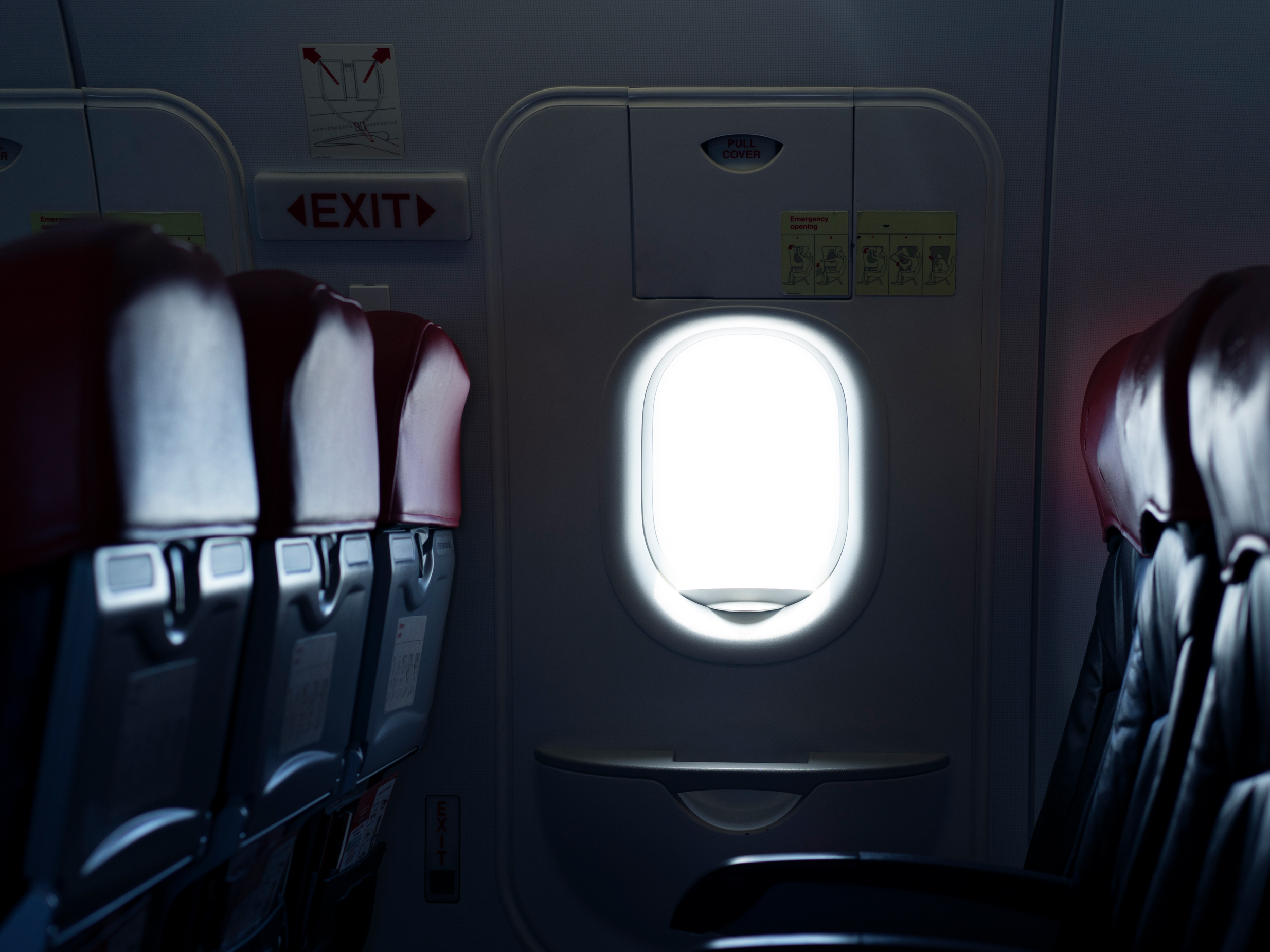 caption: Where should you sit on a plane to reduce the risk of exposure to germs spread by infectious passengers?