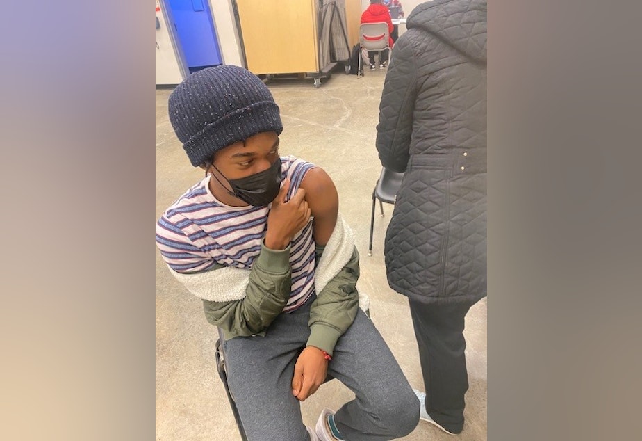 caption: KUOW listener Chris Porter sent us this photo of his son getting a Covid-19 vaccination shot.