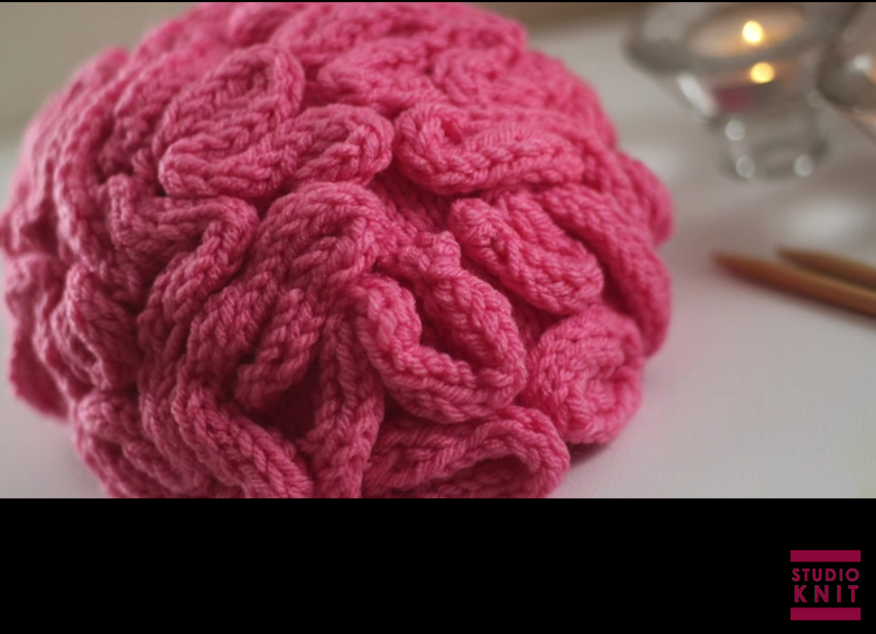 caption: Screenshot of a brain hat knitting tutorial by Studio Knit on YouTube