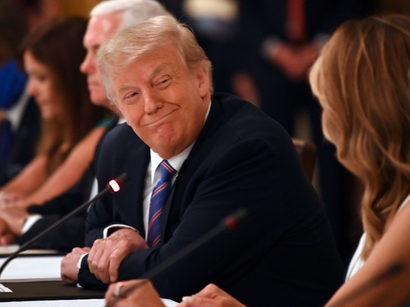 caption: President Trump, seen here at a roundtable discussion at the White House on Tuesday, rebuked the CDC for its guidelines on reopening schools in a tweet Wednesday.