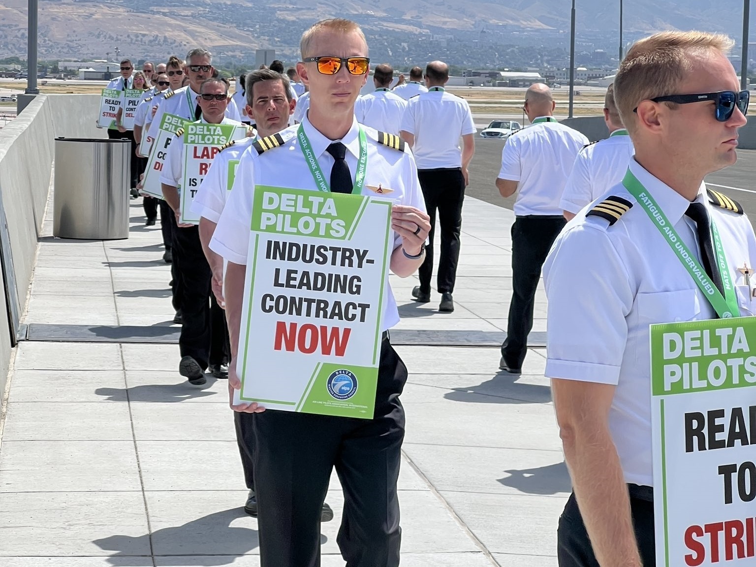 caption: Delta pilots engaged in demonstrations at seven airports around the U.S. on Thursday calling for higher pay, among other things. This photo was taken at Salt Lake City International Airport.