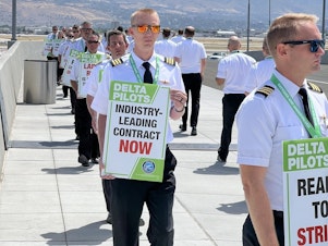 caption: Delta pilots engaged in demonstrations at seven airports around the U.S. on Thursday calling for higher pay, among other things. This photo was taken at Salt Lake City International Airport.