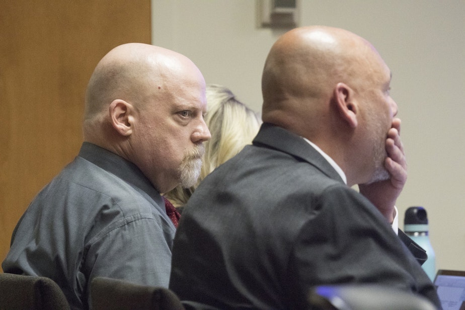 caption: William Talbott II, left, stares at his attorney Jon Scott after Scott presented his opening statement in Talbott' trial for double-murder , Friday, June 14, 2019, at the Snohomish County Courthouse in Everett, Washington.