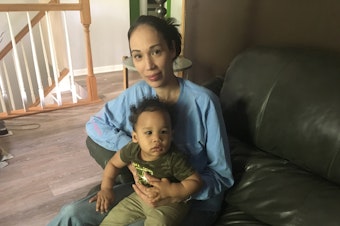 caption: Natalie Lynch at a relative's home with her youngest child, Maycen. In 2014, when Lynch was pregnant with her older child, she spent two weeks before giving birth in<strong> </strong>a prison cell, mostly alone.