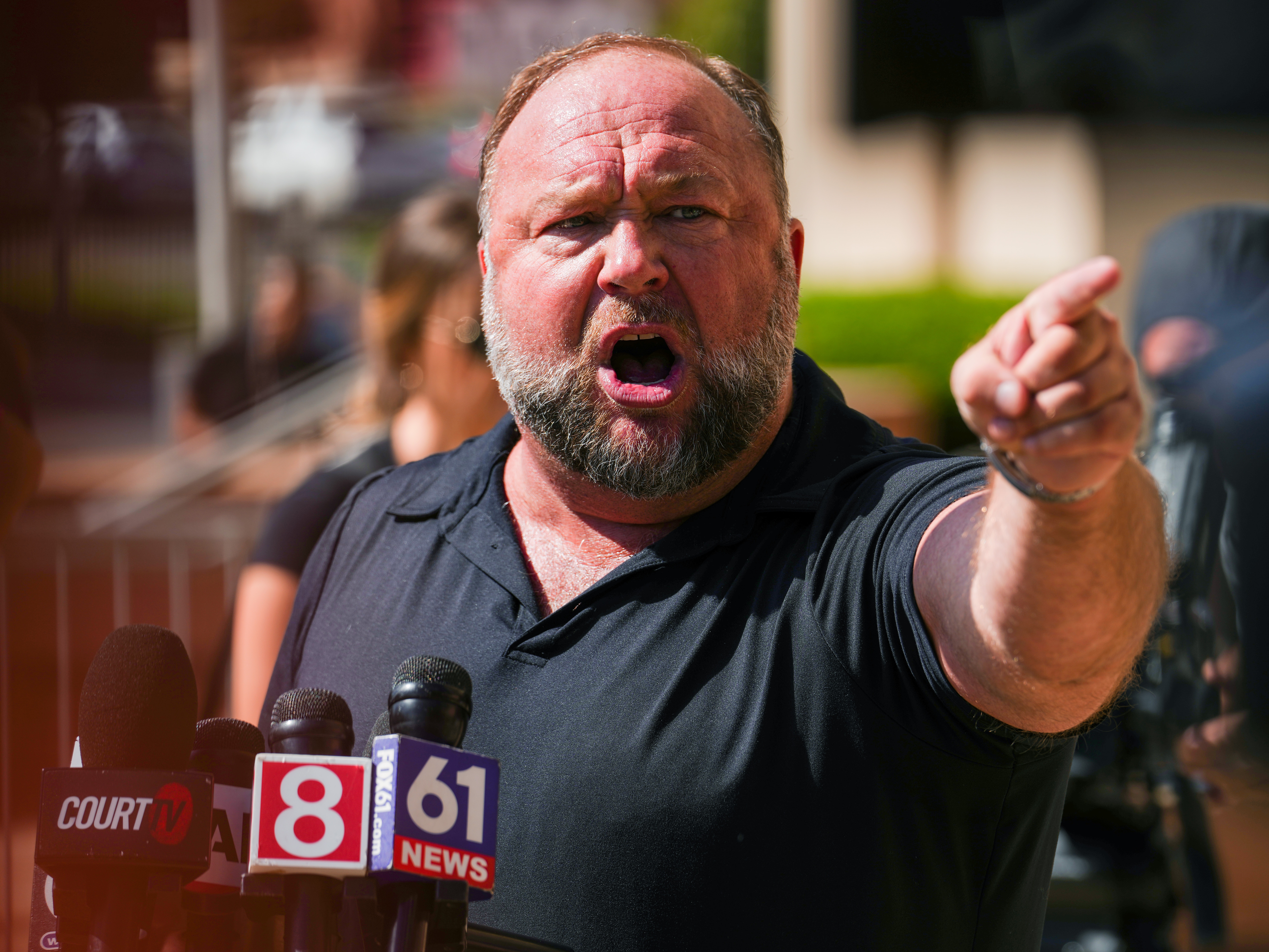 caption: InfoWars founder Alex Jones, speaking in 2022, was dealt another legal setback on Wednesday. A state judge in Texas ordered Infowars' assets to be turned over to a state receiver. The proceeds will go to the families of the children killed in the 2012 Sandy Hook Elementary School shooting. They won a $1.3 billion defamation case against Jones after he spread bogus conspiracies about the shooting.