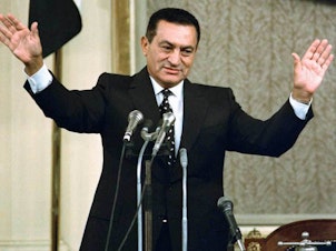 caption: Mubarak waves to parliament on Oct. 12, 1993, after being sworn in for a third six-year term as president. He had promised to serve only two terms.