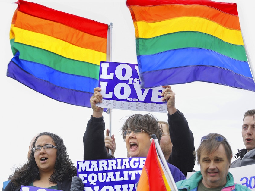 caption: Supporters rally for Social Security benefits for same-sex couples in Springfield, Ill., at a marriage equity event in 2013.