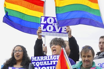 caption: Supporters rally for Social Security benefits for same-sex couples in Springfield, Ill., at a marriage equity event in 2013.