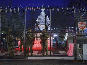 caption: National Guard troops reinforce the security zone on Capitol Hill in Washington early Tuesday, before President-elect Joe Biden is sworn in as the 46th president on Wednesday.