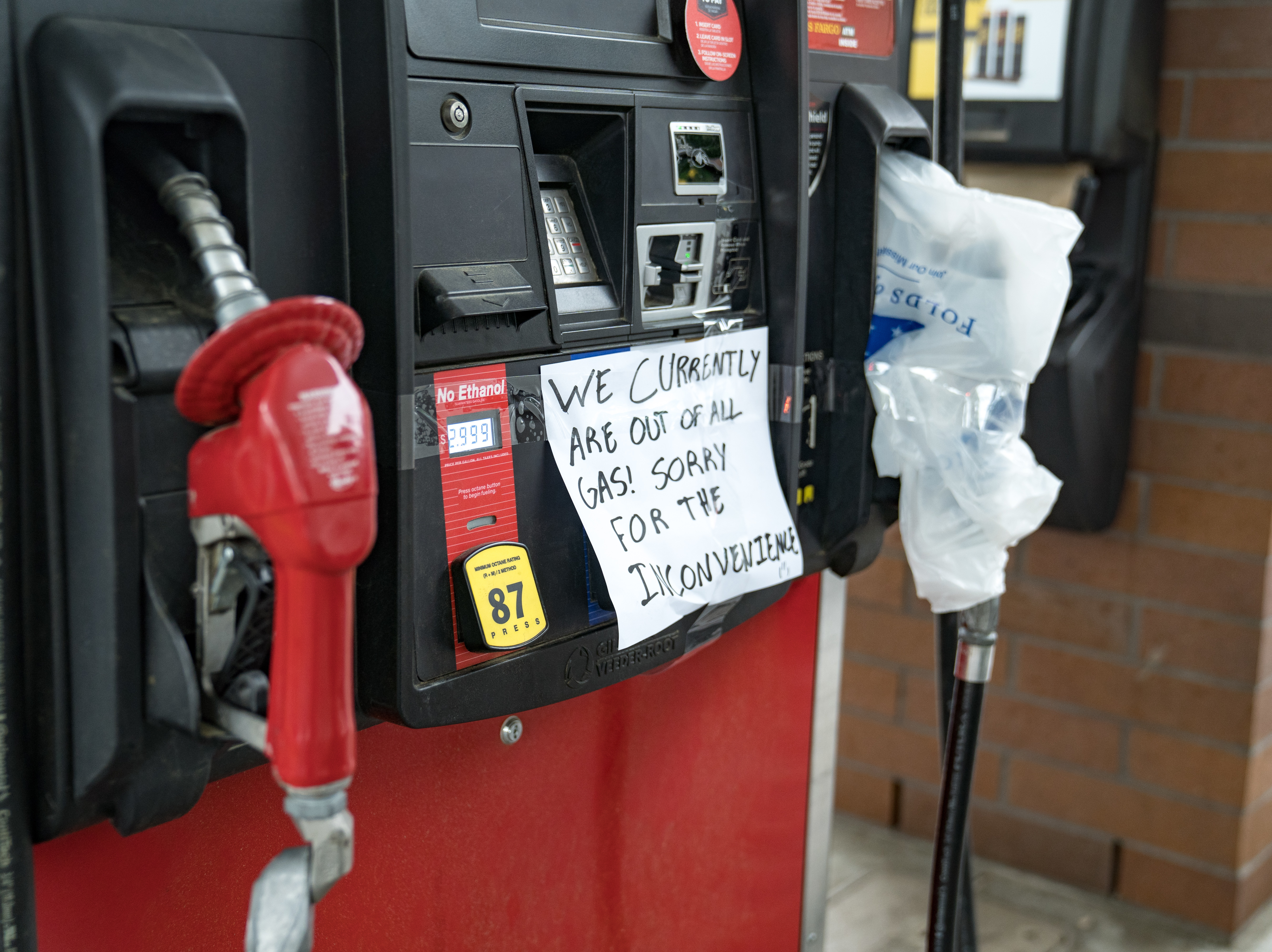 caption: Cars line up at a QuickTrip on May 11, 2021 in Atlanta. The White House said it would ease new restrictions on the shipments of fuel as panic buying leads to gasoline shortages at gas stations across the Southeast after a hack attack shut down a critical pipeline.