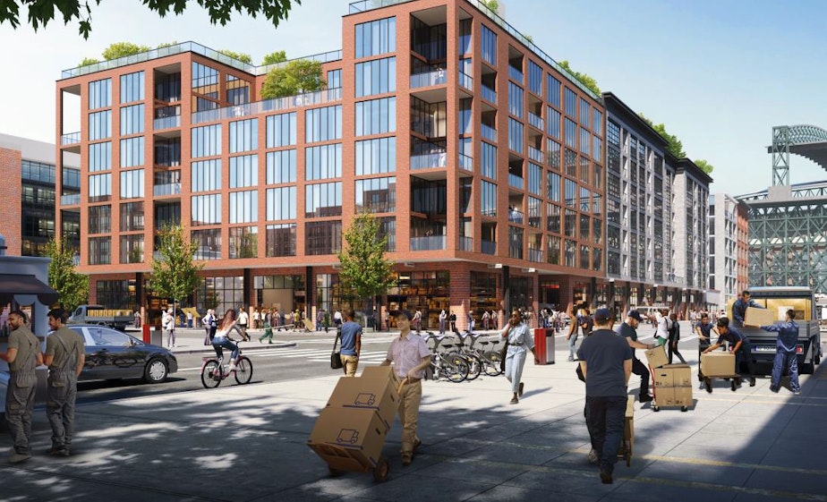 caption: "Workforce Housing Over Makerspace" rendering showing Occidental Avenue S looking North towards the baseball stadium