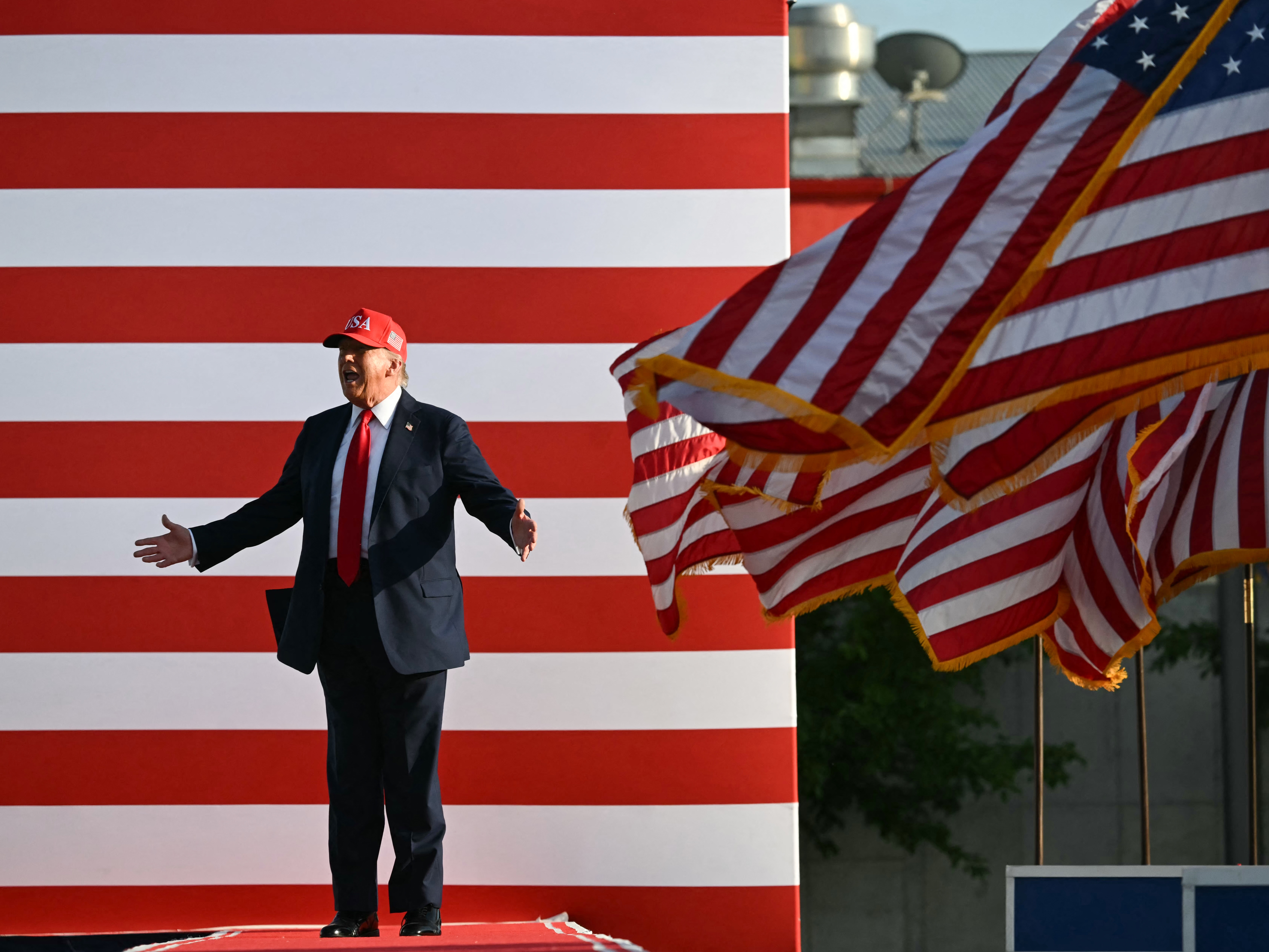 caption: President Trump steps onstage to deliver remarks at the Salute to America celebration at the Iowa State Fairgrounds in Des Moines on July 3, 2025.