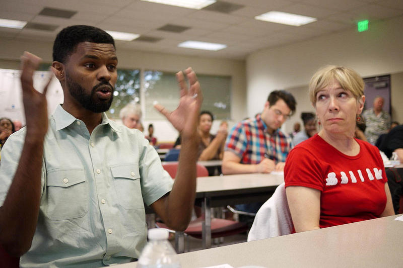caption: Sean Conner (left) speaks about his fear of a police encounter while driving.