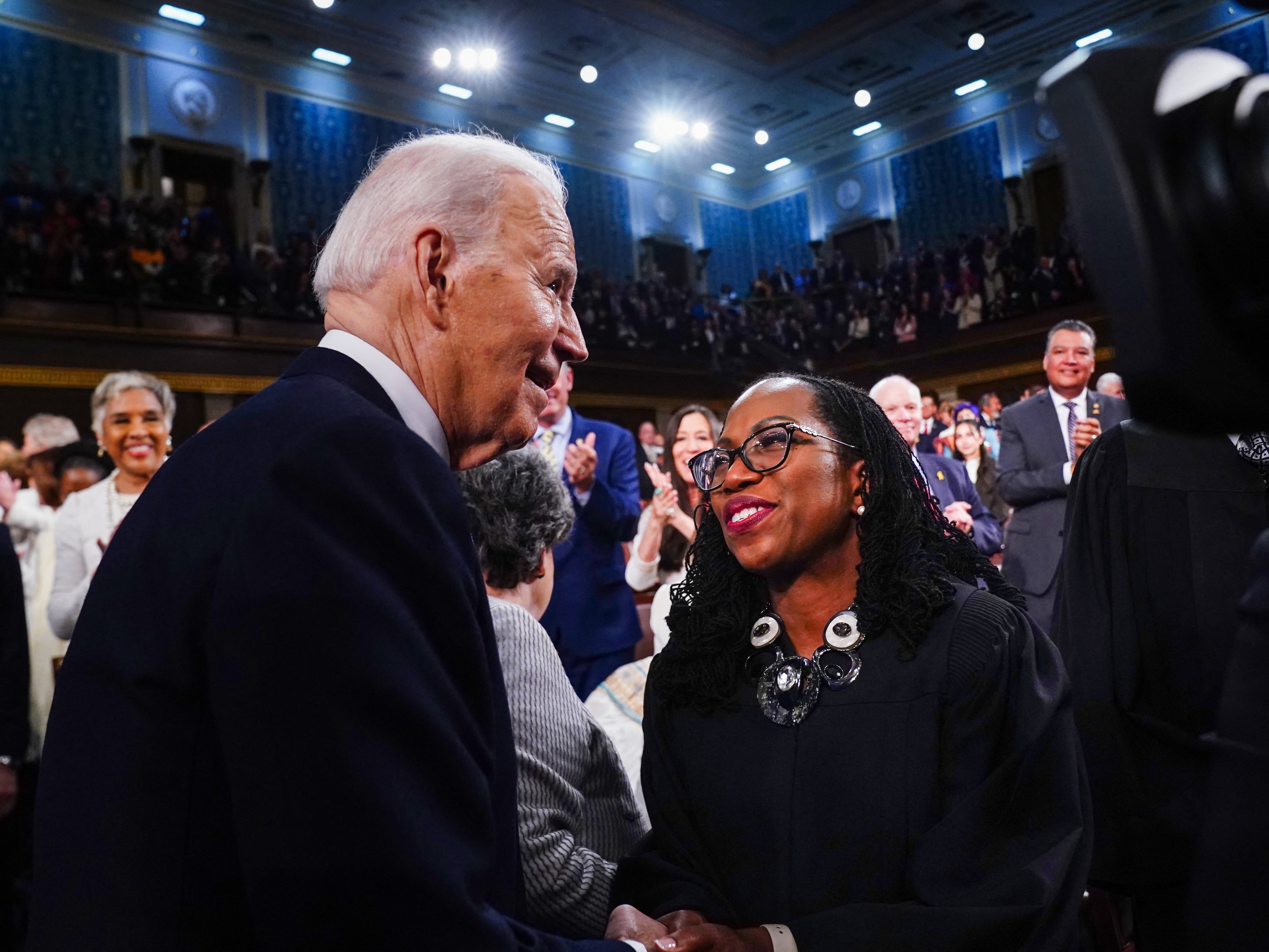 caption: President Biden (L) greets Supreme Court Associate Justice Ketanji Brown Jackson (R) as he arrives to the House Chamber of the U.S. Capitol for his State of the Union address on March 7, 2024.