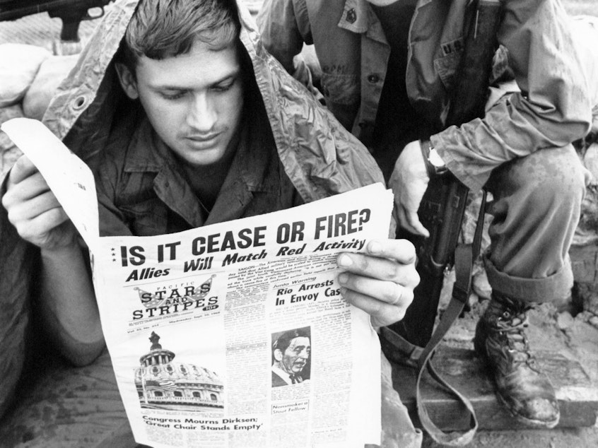 caption: U.S. troops read <em>Stars and Stripes</em> newspaper in Cu Chi, South Vietnam in 1969. The Pentagon plans to shut down the paper, aimed at U.S. military personnel, at the end of this month.