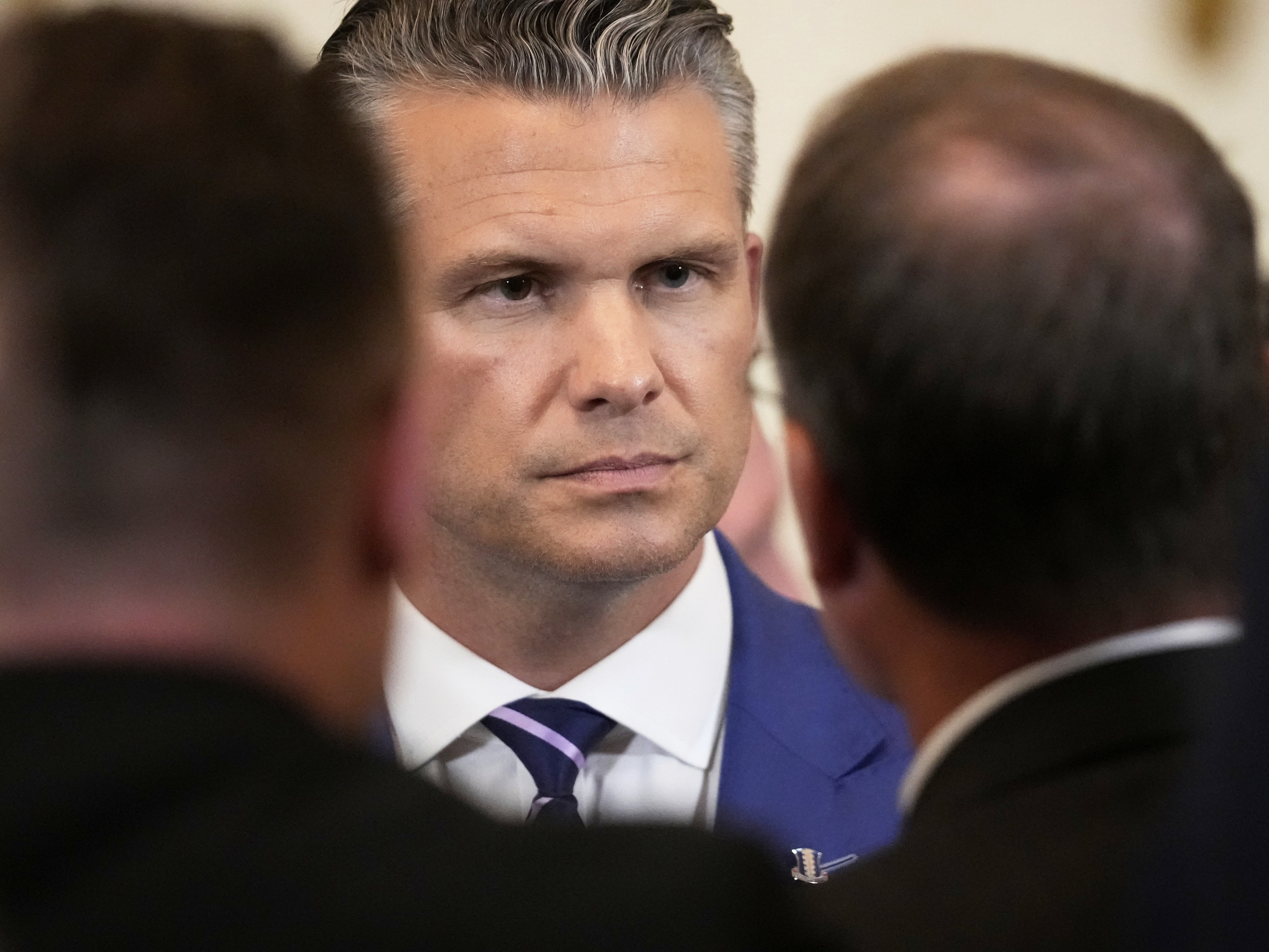 caption: Defense Secretary Pete Hegseth attends an event to mark National Purple Heart Day in the East Room of the White House on Aug. 7, 2025, in Washington.