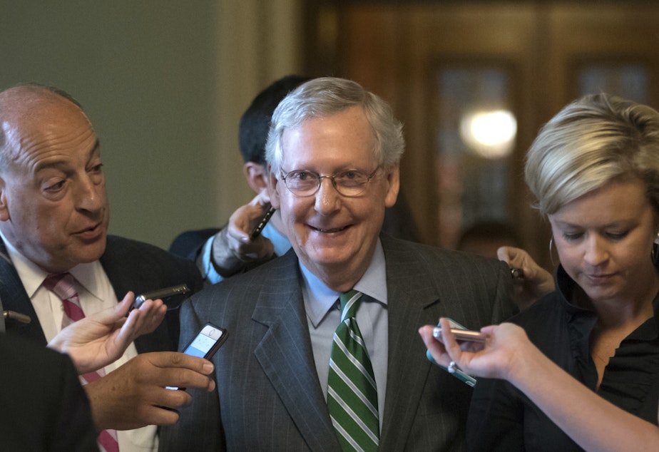 Senate Majority leader Mitch McConnell smiles as he leaves the chamber after announcing the release of the Republicans' health care bill Thursday, June 22, 2017.