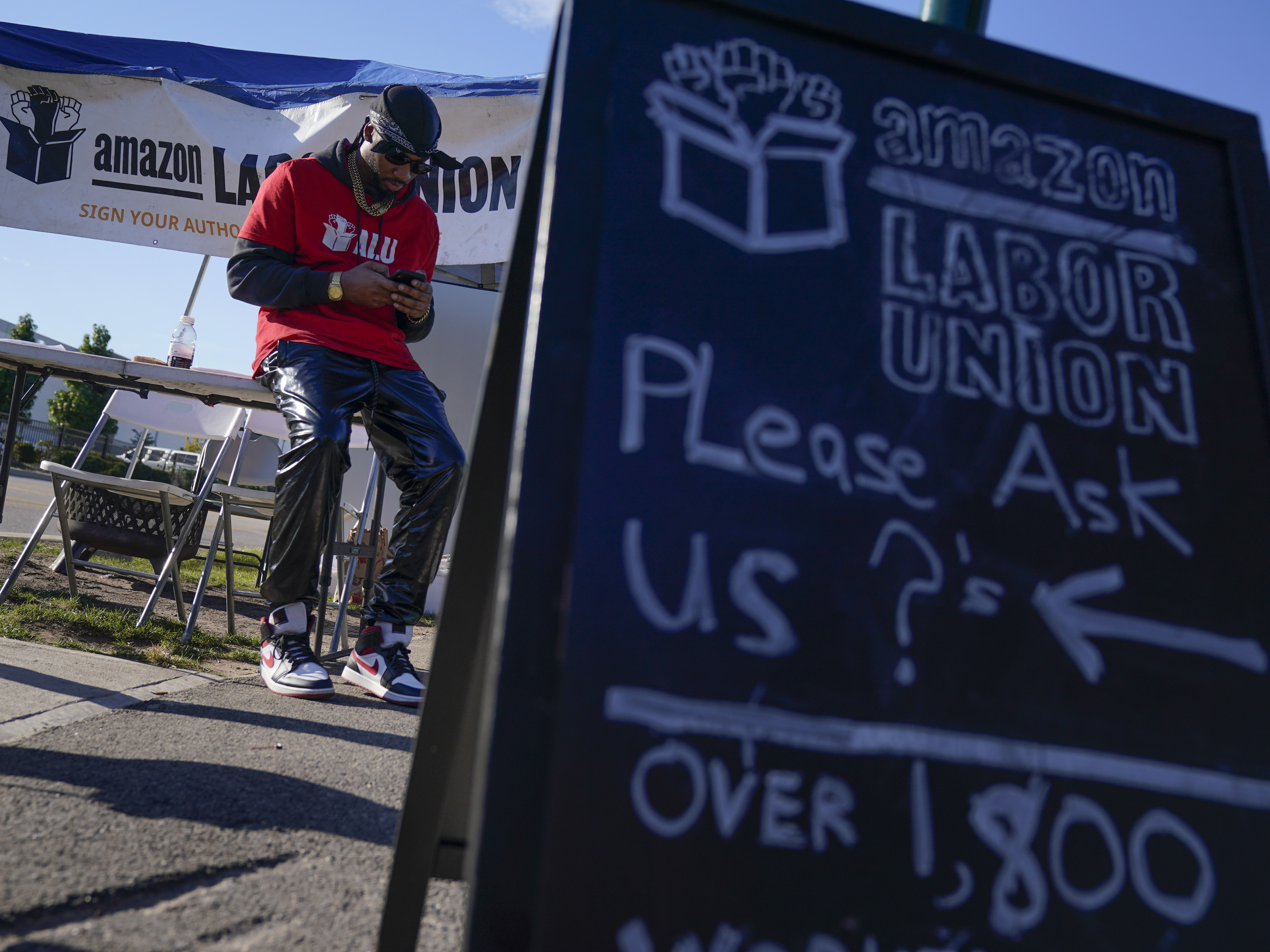 caption: Chris Smalls, who runs the self-organized worker group Amazon Labor Union, has been gathering signatures from Amazon warehouse workers on Staten Island in support of a union election.
