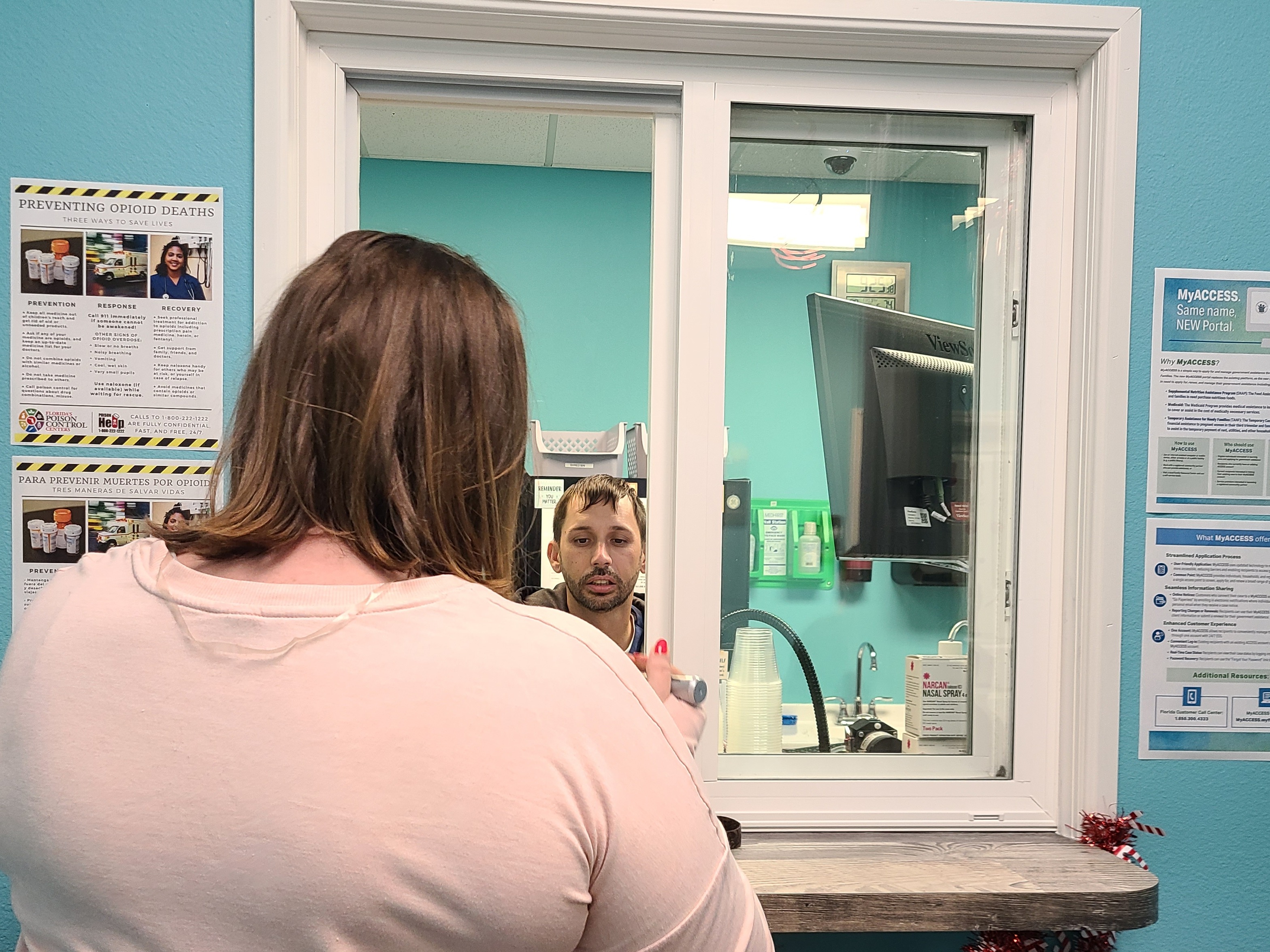 caption: Stephanie, who asked that only her first name be used, picks up her methadone prescription at the Operation PAR clinic in Inverness, Florida. 