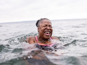caption: Mikki Smith lets out a cry as she adjusts to the frigid water. It was her first time with the Puget Sound Plungers in Seattle, Washington.