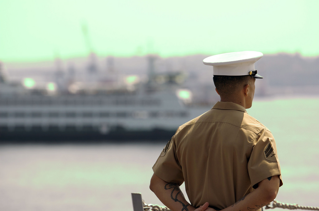 caption: A Marine's arm tattoo is visible on his lower arm. 