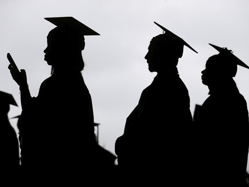 caption: New graduates line up before the start of a community college commencement in East Rutherford, N.J., on May 17, 2018.