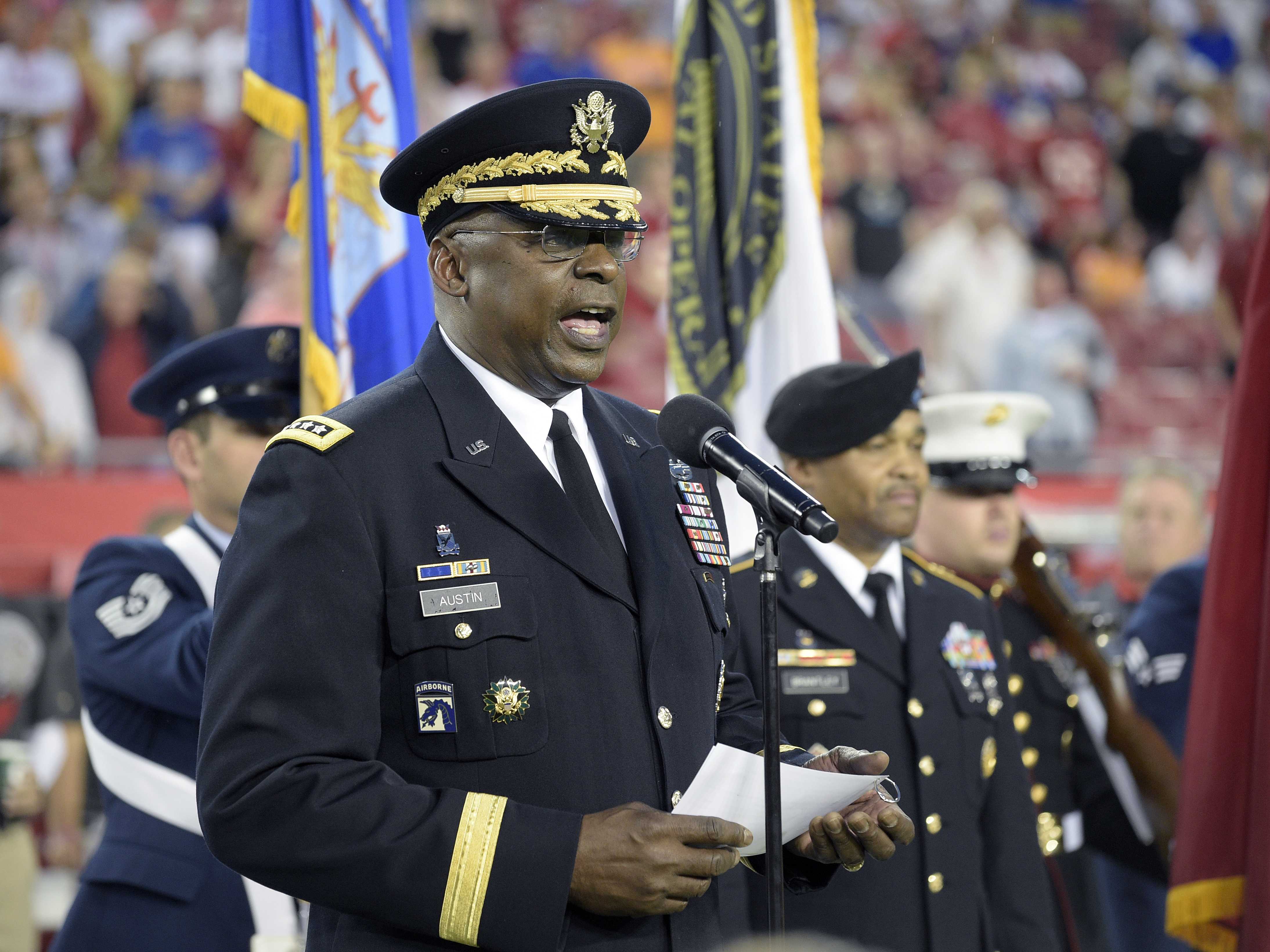 caption: Gen. Lloyd Austin addresses military recruits during an induction ceremony in Tampa, Fla., in 2015.