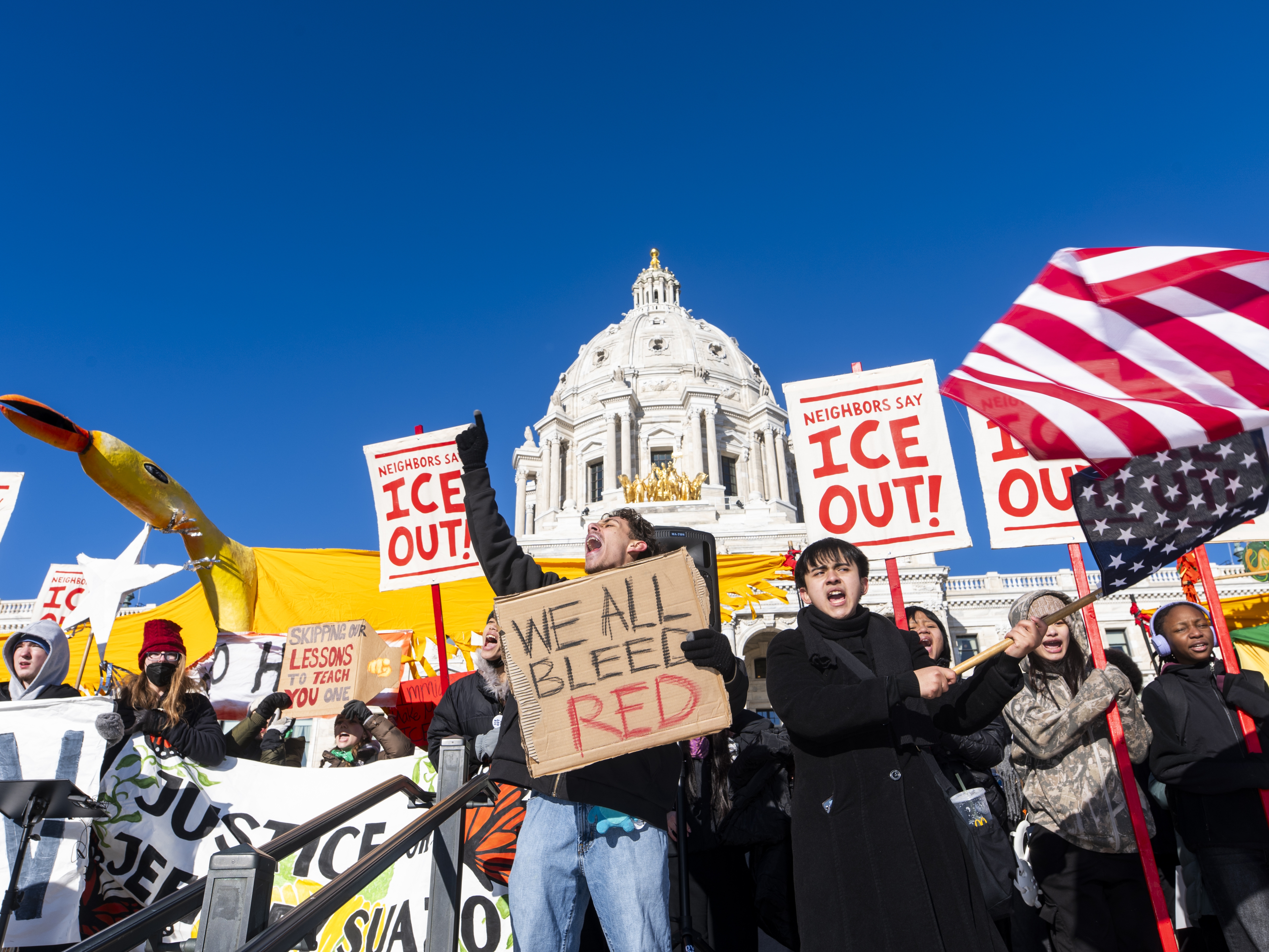 caption: Students cheer during a school walkout to protest federal immigration enforcement at the state Capitol on Jan. 14 in St. Paul, Minn.