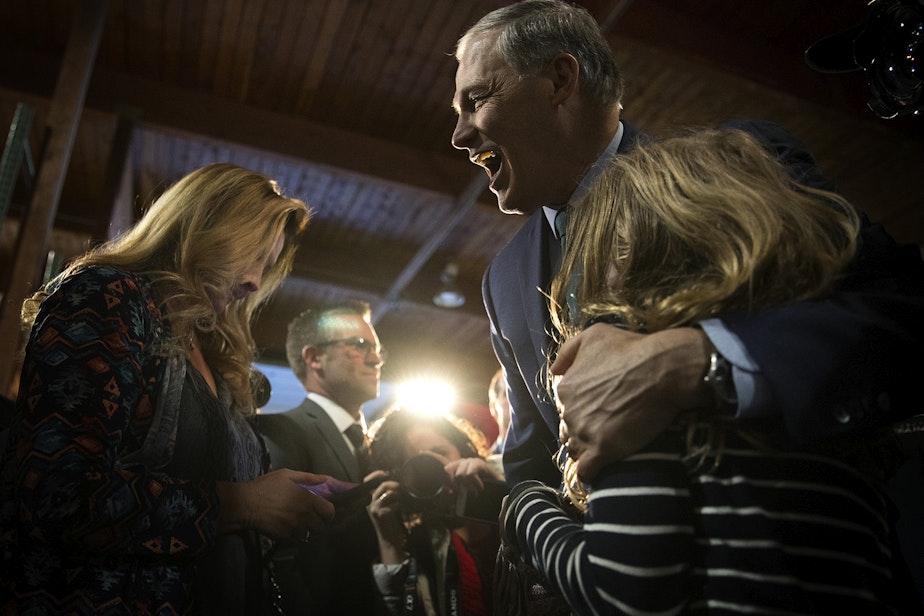 caption: Governor Jay Inslee hugs Lucia Noreus, 11, a 5th-grader from Redmond, after announcing his candidacy for President on Friday, March 1, 2019, at A&R Solar on Martin Luther King Jr. Way in Seattle.