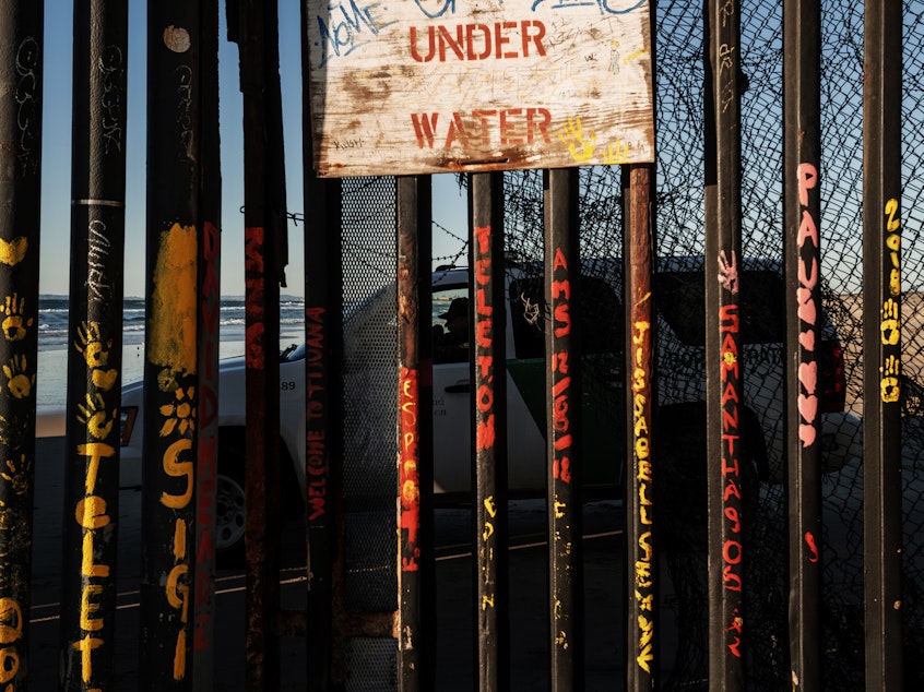 caption: A Border Patrol officer inside his vehicle guards the border fence near San Diego across the border from Tijuana, Mexico.