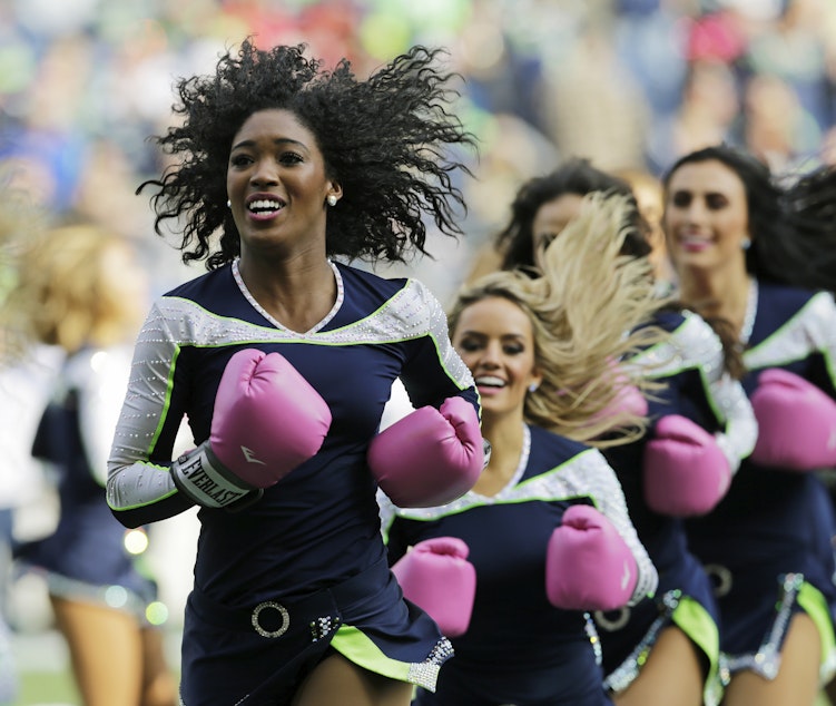 caption: Seattle Seahawks Sea Gals cheerleaders perform during halftime of an NFL football game Sunday, Oct. 29, 2017, in Seattle. The gloves were part of the Seahawks and NFL football's Crucial Catch campaign to support the fight against breast cancer.